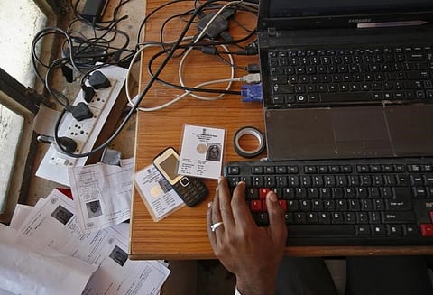 An operator works on his table while enrolling villagers for the Unique Identification (UID) database system at an enrolment centre at Merta district, Rajasthan, February 21, 2013. | Reuters