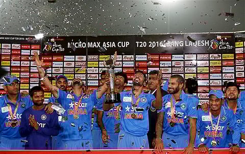 Indian players and support staff celebrate with the trophy after winning the Asia Cup Twenty20 international cricket final match against Bangladesh in Dhaka, Bangladesh, Sunday, March 6, 2016. India won the Asia Cup for the sixth time after beating host B