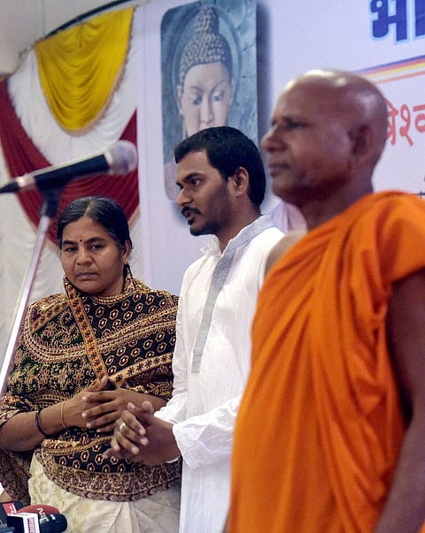 Rohith Vemula's mother Radhika and brother Naga Chaitanya Vemula embrace Buddhism on the occasion of BR Ambedkar's 125th birth anniversary in Mumbai on Thursday. | PTI