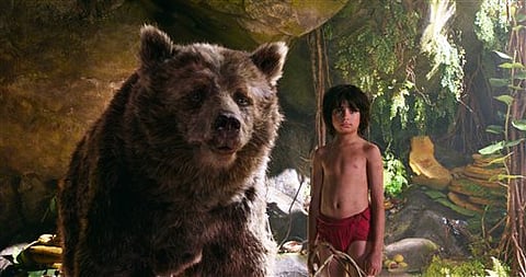 In this image released by Disney, Mowgli, portrayed by Neel Sethi, right, and Baloo the bear, voiced by Bill Murray, appear in a scene from, "The Jungle Book.". |AP