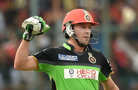 Royal Challengers Bangalore AB De Villiers celebrates his century during the IPL T20 match against Gujarat Lions at Chinnaswamy Stadium in Bengaluru on Saturday. | PTI