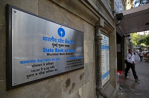 A man walks out of the State Bank of India main branch in Mumbai, India. (Reuters)