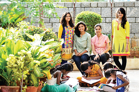 Volunteers of Kora Kagaz who donated notebooks to children (Photo | R SATISH BABU)