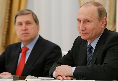 Russian President Vladimir Putin, right, and his foreign affairs adviser Yury Ushakov