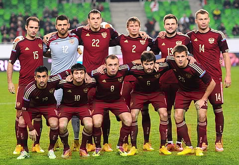 Russia's players (L -R) (1st row) midfielder Aleksandr Samedov, midfielder Alan Dzagoev, midfielder Denis Glushakov, defender Georgi Shchennikov and forward Maksim Kanunnikov, (2nd row ) midfielder Roman Shirokov, goalkeeper Jurij Lodigin, forward Artyom