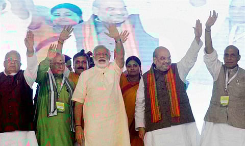 Prime Minister Narendra Modi with Union Minister Rajnath Singh, BJP President Amit Shah and other senior leaders during 'Parivartan Rally' at Parade Ground in Allahabad on Monday. PTI 