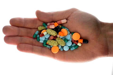 A person holds pharmaceutical tablets and capsules in illustration picture in Ljubljana. (Reuters)