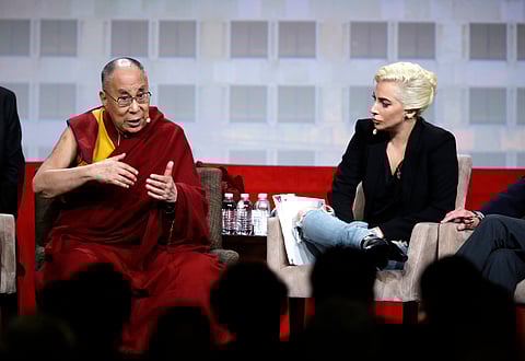 Lady Gaga listens as the Dalai Lama speaks during a question and answer session at the the U.S. Conference of Mayors in Indianapolis. (AP)