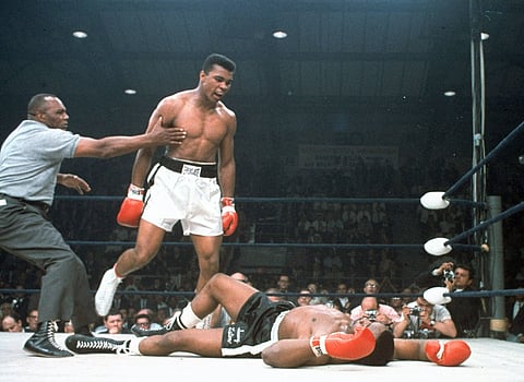 FILE - In this May 25, 1965, file photo, heavyweight champion Muhammad Ali is held back by referee Joe Walcott, left, after Ali knocked out challenger Sonny Liston in the first round of their title fight in Lewiston, Maine | AP