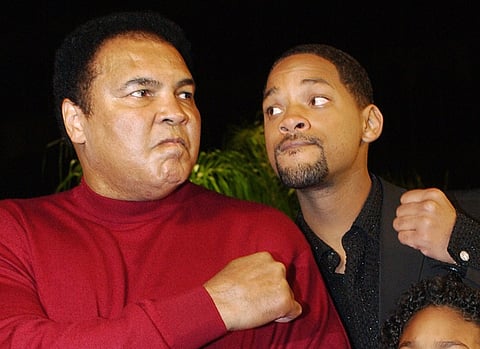In this Dec. 12, 2001 file photo, Muhammad Ali, left, and Will Smith pose at the premiere of the film "Ali," in Los Angeles. | AP
