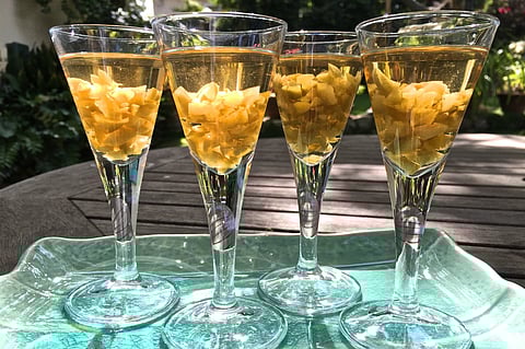 Umeshu shooters with chopped macerated ume (Japanese green plums). (Reuters)