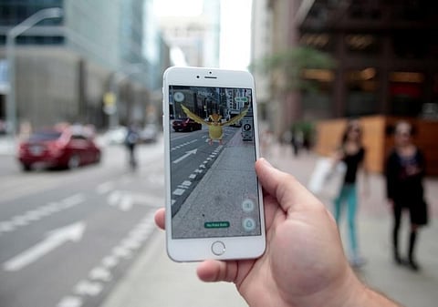 A "Pidgey" Pokemon is seen on the screen of the Pokemon Go mobile app, Nintendo's new scavenger hunt game which utilizes geo-positioning, in a photo illustration taken in downtown Toronto, Ontario, Canada. (Reuters)