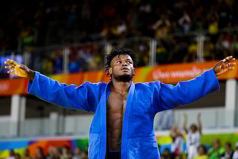 Popole Misenga, who competes for the Refugee Olympic Team, reacts after winning his first match against India's Avtar Singh during the men's 90-kg judo competition at the 2016 Summer Olympics in Rio de Janeiro, Brazil, Wednesday, Aug. 10, 2016. | AP