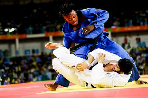 Popole Misenga, blue, of the Refugee Olympic Team, competes against India's Avtar Singh during the men's 90-kg judo competition at the 2016 Summer Olympics in Rio de Janeiro, Brazil, Wednesday, Aug. 10, 2016. | AP