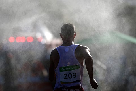 Artur Brzozowski, of Poland, walks through the mist during the men's 20km race walk final at the 2016 Summer Olympics in Rio de Janeiro, Brazil, Friday, Aug. 12, 2016. | AP