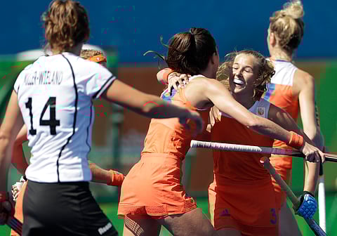 Netherlands' Xan de Waard, right, celebrates her goal with her teammate Netherlands' Marloes Keetels, center, after she scored against Germany during a women's field hockey match at 2016 Summer Olympics in Rio de Janeiro, Brazil, Saturday, Aug. 13, 201