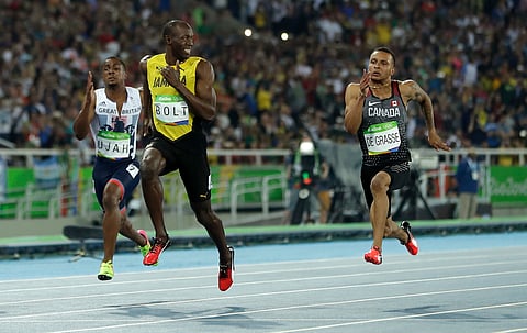 Jamaica's Usain Bolt looks to Canada's Andre De Grasse, right, during a men's 100-meter semifinal during the athletics competitions in the Olympic stadium of the 2016 Summer Olympics in Rio de Janeiro, Brazil, Sunday, Aug. 14, 2016. | AP