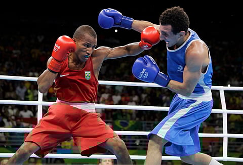 Brazil's Robson Conceicao, left, fights France's Sofiane Oumiha during a men's lightweight 60-kg final boxing match at the 2016 Summer Olympics in Rio de Janeiro, Brazil. | AP
