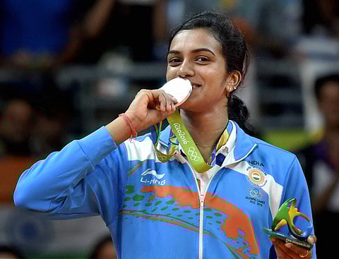 India's Pusarla V Sindhu kisses her silver medal after her match with Spain's Carolina Marin in women's Singles final at the 2016 Summer Olympics at Rio de Janeiro in Brazil. | PTI