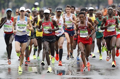 Athletes run during the Men's Marathon athletics event at the Rio 2016 Olympic Games in Rio de Janeiro on August 21, 2016. | AFP