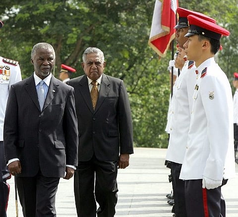 South African President Thabo Mbeki (L) followed by Singaporean counter SR Nathan during a welcoming ceremony at the Istana Presidential Palace in Singapore 21 April 2005. | AFP
