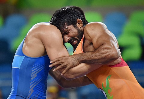 India's Yogeshwar Dutt fights with Mongolia's wrestler Mandakhnaran Ganzorig during the Men's 65kg Freestyle wrestling match at Summer Olympics 2016 in Rio de Janeiro in Brazil on Sunday. | PTI