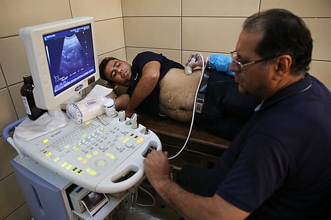 Sajjad Ghanbari undergoes a medical exam as part of the process of selling his kidney, in a clinic in downtown Tehran, Iran. | AP