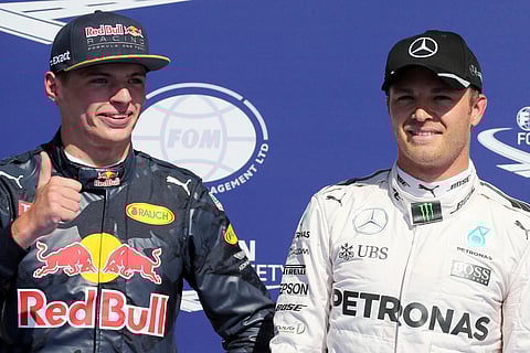 Red Bull driver Max Verstappen of the Netherlands, left, gives the thumbs up as he stands next to Mercedes driver Nico Rosberg of Germany on the podium at the Belgian Formula One Grand Prix circuit in Spa-Francorchamps.(Photo|AP)