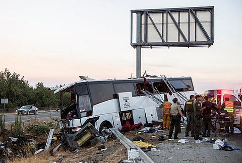 Rescue crews work at the scene of a charter bus crash on northbound Highway 99 between Atwater and Livingston. (AP)
