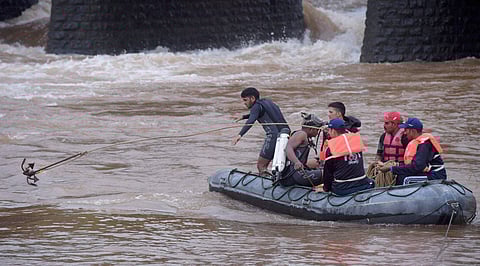 Indian Navy personnel carry out rescue work in Savitri River near the collapsed Mahad-Poladpur bridge on the Mumbai-Goa highway in Mahad Raigad district on Thursday. | PTI