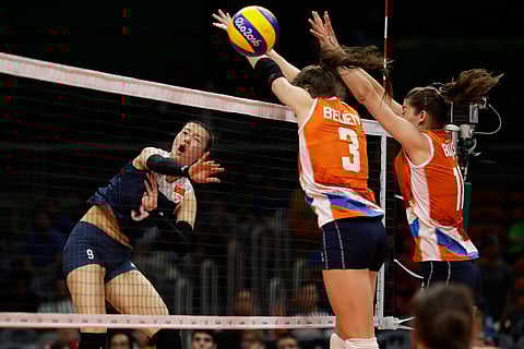 China's Zhang Changning, left, hits the ball past Netherlands' Yvon Belien (3) and Anne Buijs, right, during a women's preliminary volleyball match at the 2016 Summer Olympics in Rio de Janeiro, Brazil, Saturday, Aug. 6, 2016. | AP