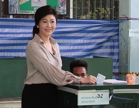 Former Thailand's Prime Minister Yingluck Shinawatra poses as she casts her vote in a national referendum on a new constitution at a polling station in Bangkok