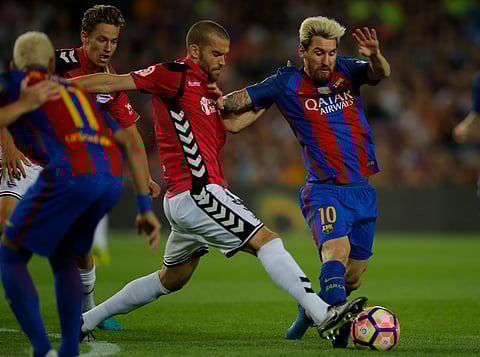 FC Barcelona's Lionel Messi, right, duels for the ball against Alaves's Victor Laguardia during the Spanish La Liga soccer match between FC Barcelona and Alaves at the Camp Nou in Barcelona, Spain, Saturday, Sept. 10, 2016. | AP