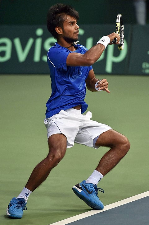 Indian player Sumit plays a shot against Spain's Marc Lopez during the Davis cup match at DLTA stadium in New Delhi. | PTI