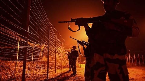 In this file photograph taken on January 17, 2013, Indian Border Security Force (BSF) soldiers patrol along a border fence at an outpost along the Line of Control (LOC) between India-Pakistan at Abdul.