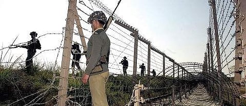Army soldiers stand guard at the Indo-Pak border in Jammu and Kashmir