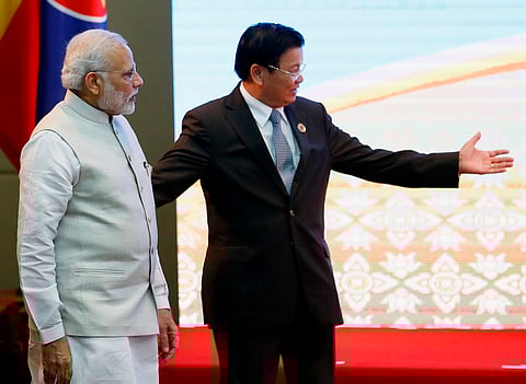 ndia's Prime Minister Narendra Modi, left, is escorted to a photo session by Laos' Prime Minister Thongloun Sisoulith prior to the start of the ASEAN-India summit in the ongoing 28th and 29th ASEAN Summits at the National Convention Center, Thursday, Se