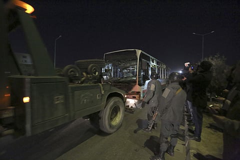 Afghan security forces remove a damaged vehicle after two large bombings in Kabul. (Photo | AP)