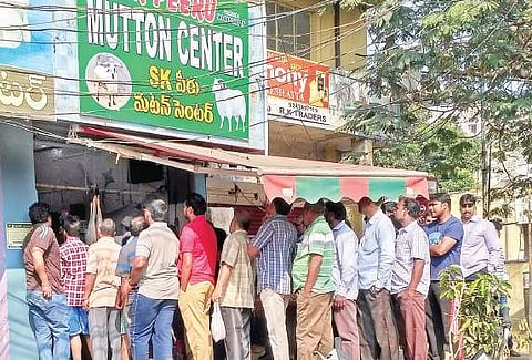 People stand in long queues in front of a mutton shop near Seethampeta in Visakhapatnam on Sunday | Express