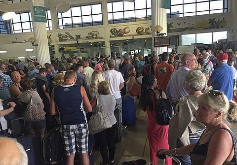 Tourists gather at the airport in Banjul as tour operators send in extra flights to evacuate them Wednesday Wednesday Jan. 18, 2017. As the political crisis deepened, special flights were being organized to evacuate British and other tourists from Gambia,