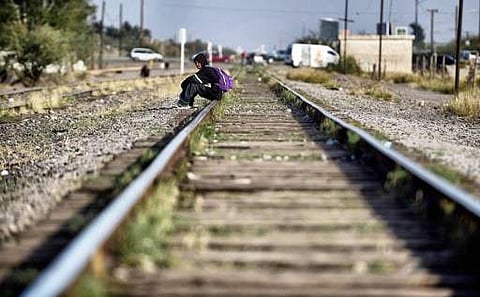 A migrant rests on the train tracks in the community of Caborca in Sonora state, Mexico, on January 12, 2017. Hundreds of Central American and Mexican migrants attempt to cross the US border daily.(Photo | AFP)