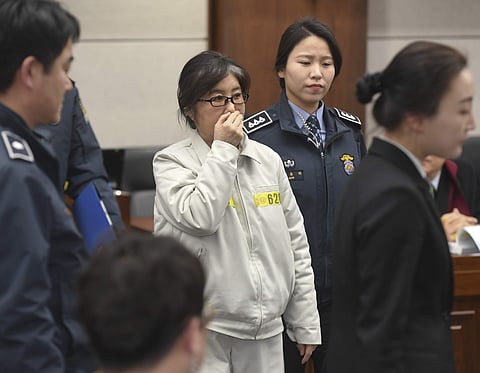 Choi Soon-sil, the the jailed secretive confidante of South Korean President Park Geun-hye, arrives for her trial for a political scandal engulfing impeached President Park at a courtroom of Seoul Central District Court in Seoul, South Korea, Tuesday, Jan
