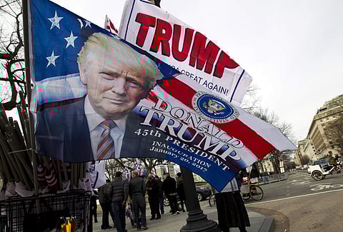 Flags with the image of President-elect Donald Trump are displayed for sale on Pennsylvania Avenue in Washington, Thursday, Jan. 19, 2017. | AP