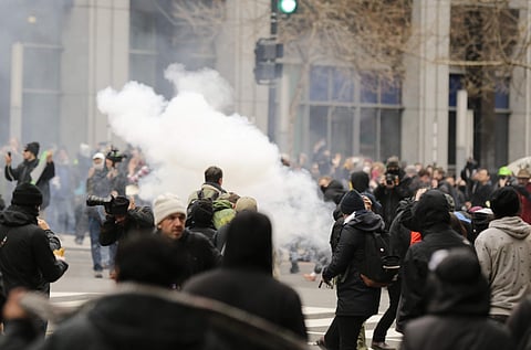 Police deploy smoke and pepper grenades during clashes with protesters in northwest Washington, Friday, Jan. 20, 2017. (Photo | AP)