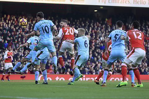 Arsenal's Shkodran Mustafi, center, scores his side's first goal of the game during their English Premier League soccer match against Burnley at The Emirates Stadium, London, Sunday, Jan. 22, 2017. | AP
