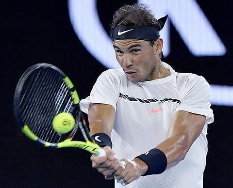 Spain's Rafael Nadal plays a backhand to France's Gael Monfils during their fourth round match at the Australian Open tennis championships in Melbourne. | AP