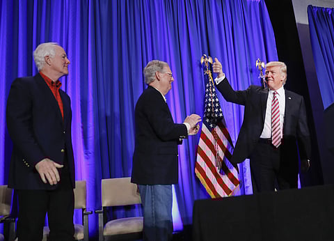 Senate Majority Whip John Cornyn of Texas, left, and Senate Majority Leader Mitch McConnell of Ky., watch as President Donald Trump arrives before speaking at the House and Senate GOP lawmakers at the annual policy retreat in Philadelphia, Thursday, Jan. 