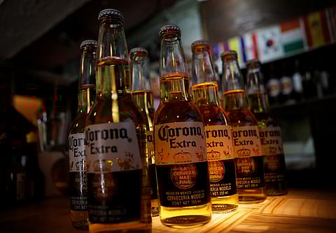 Bottles of Corona beer, the flagship brand of Group Modelo, are pictured at a restaurant in Mexico City, Mexico January 27, 2017. REUTERS