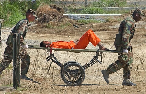 In this Feb. 2, 2002 file photo, a detainee from Afghanistan is carried on a stretcher before being interrogated by military officials at the detention facility Camp X-Ray on Guantanamo Bay U.S. Naval Base in Cuba. | AP