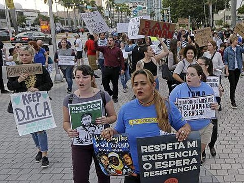 Protesters chant slogans against President Donald Trump's executive order on immigration Thursday, Jan. 26, 2017, in downtown Miami.  | AP